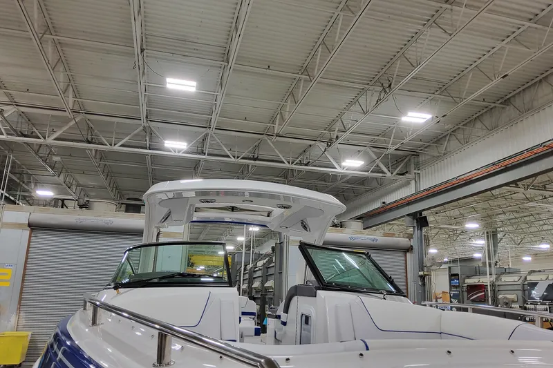 Slide: The Image of 2026 Formula 310 Bowrider I/O in a spacious indoor showroom. - 9