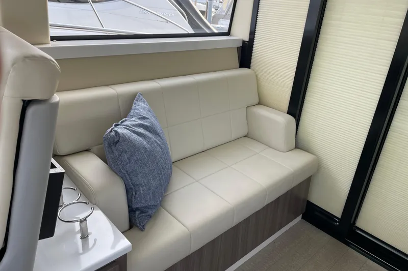 Slide: The Image of Interior of 2022 Regal 38 Grande Coupe yacht with elegant seating and table. - 13