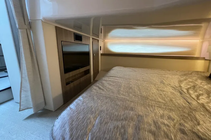 Slide: The Image of Manufacturer Provided Image: 2022 Regal 38 Grande Coupe interior cabin with modern amenities and wooden accents. - 21