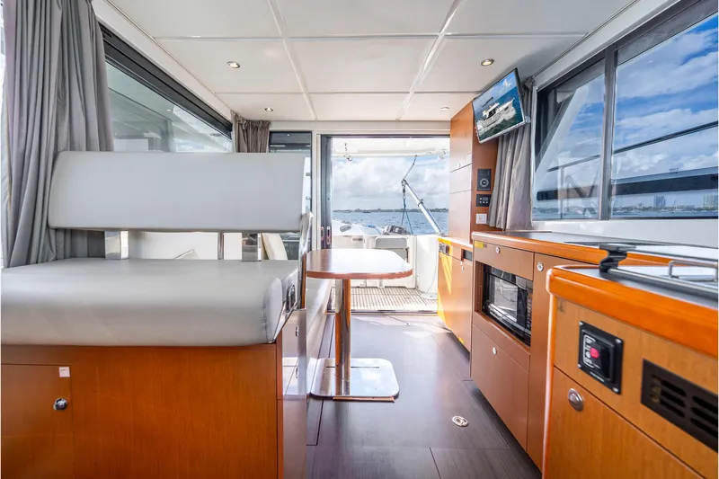 Slide: The Image of Interior of 2017 Beneteau Swift Trawler 30, featuring modern kitchen and seating area. - 10