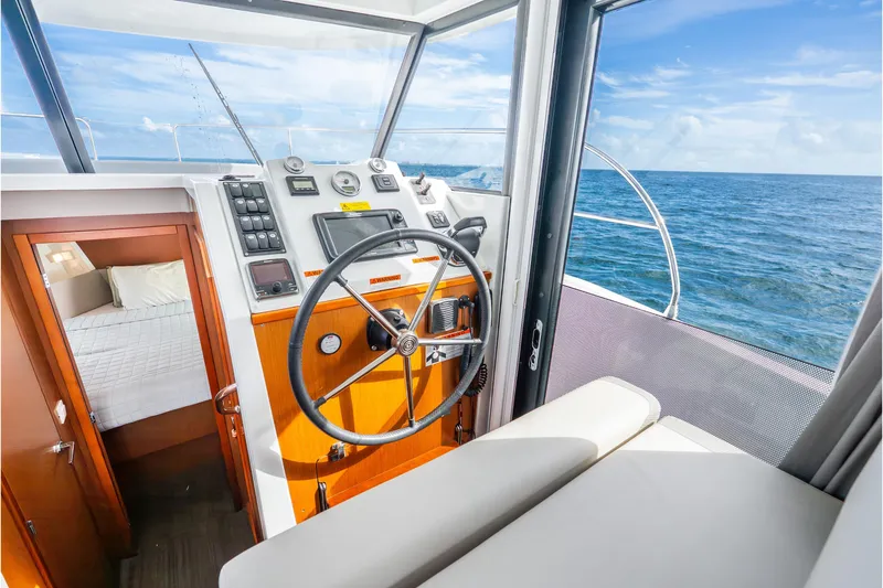 Slide: The Image of 2017 Beneteau Swift Trawler 30 helm with ocean view and cozy cabin. - 12