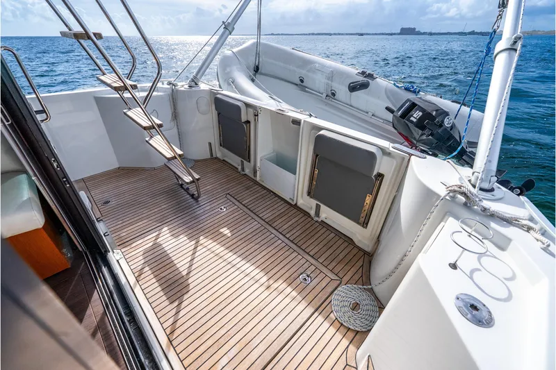 Slide: The Image of 2017 Beneteau Swift Trawler 30 deck with wooden flooring, overlooking the ocean. - 21