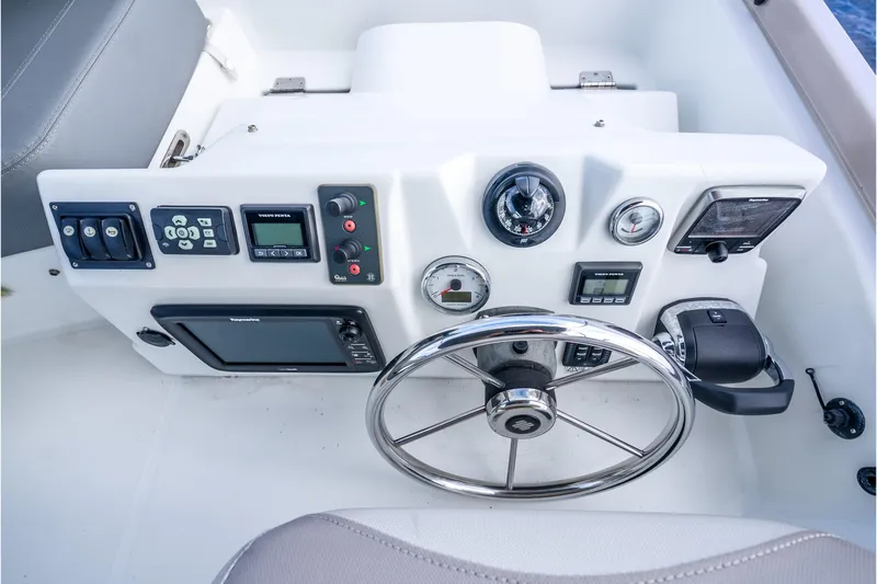 Slide: The Image of Control panel of 2017 Beneteau Swift Trawler 30 with steering wheel and navigation instruments. - 32