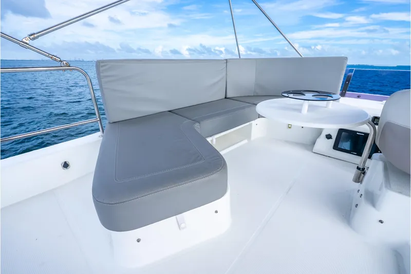 Slide: The Image of 2017 Beneteau Swift Trawler 30 deck with gray seating and ocean view. - 34