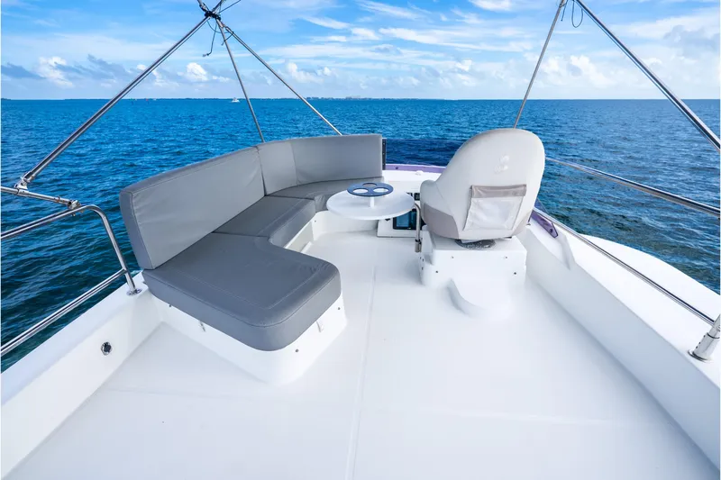 Slide: The Image of 2017 Beneteau Swift Trawler 30 deck with seating, ocean view, and clear sky. - 35