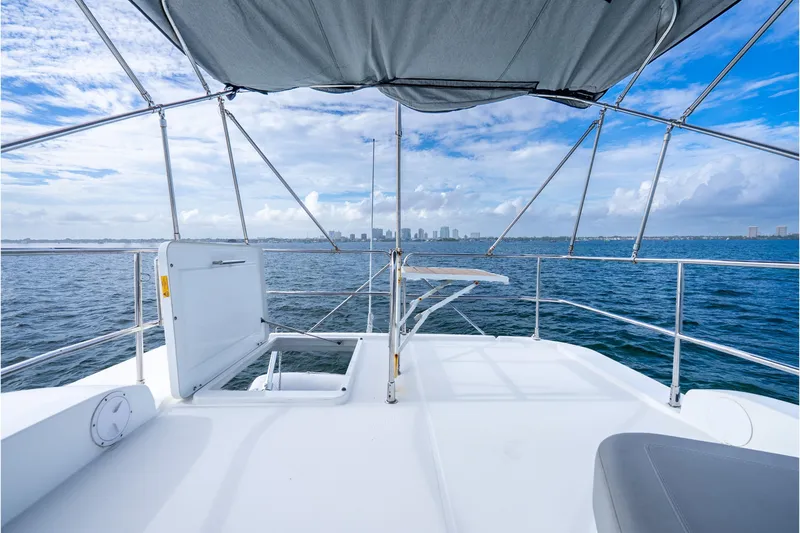 Slide: The Image of 2017 Beneteau Swift Trawler 30 deck view with ocean and city skyline. - 36