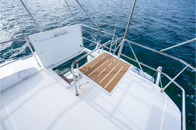 Slide: The Image of 2017 Beneteau Swift Trawler 30 deck with open hatch, overlooking ocean waters. - 37