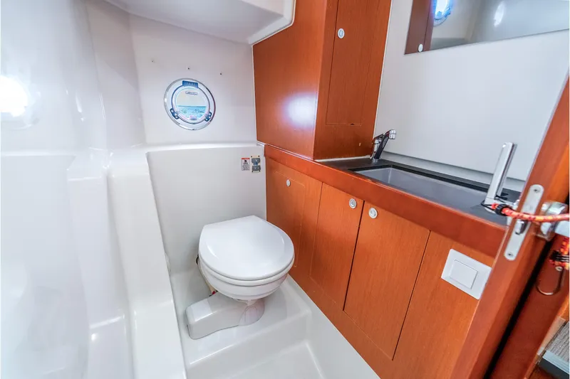 Slide: The Image of 2017 Beneteau Swift Trawler 30 bathroom with wooden cabinetry and modern fixtures. - 38