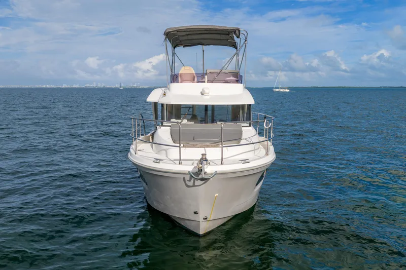 Slide: The Image of 2017 Beneteau Swift Trawler 30 on open water, clear sky background. - 4
