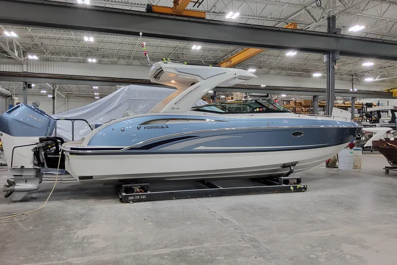 The Image of 2026 Formula 310 Bowrider OB in a showroom, showcasing sleek design and modern features. - 1