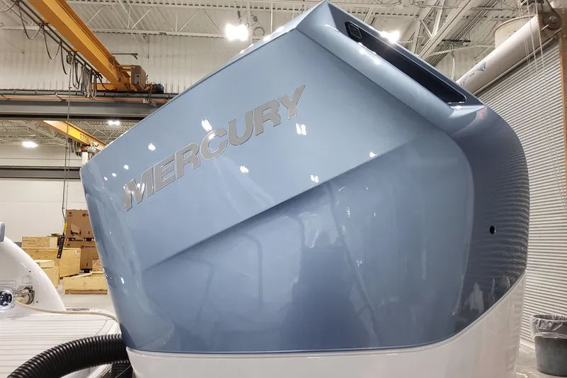 Slide: The Image of 2026 Formula 310 Bowrider OB with Mercury outboard engine in a workshop setting. - 10
