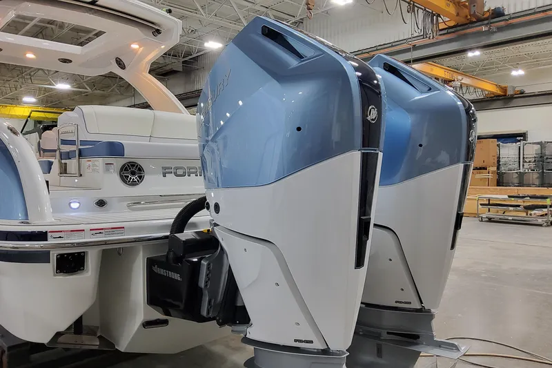 Slide: The Image of 2026 Formula 310 Bowrider OB with dual outboard engines in a showroom setting. - 11