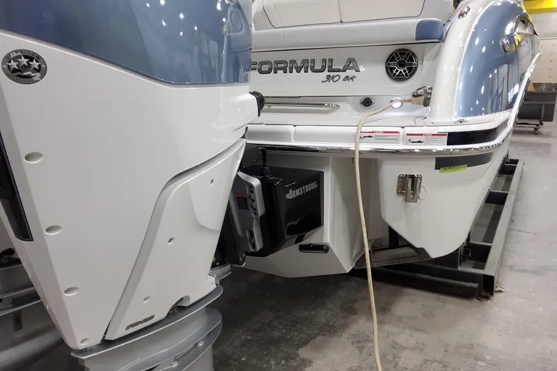 Slide: The Image of 2026 Formula 310 Bowrider OB boat with outboard motor in a showroom. - 14