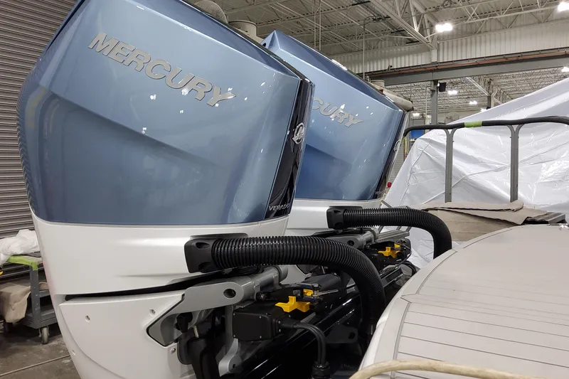 Slide: The Image of 2026 Formula 310 Bowrider OB with dual Mercury outboard engines in a showroom. - 16