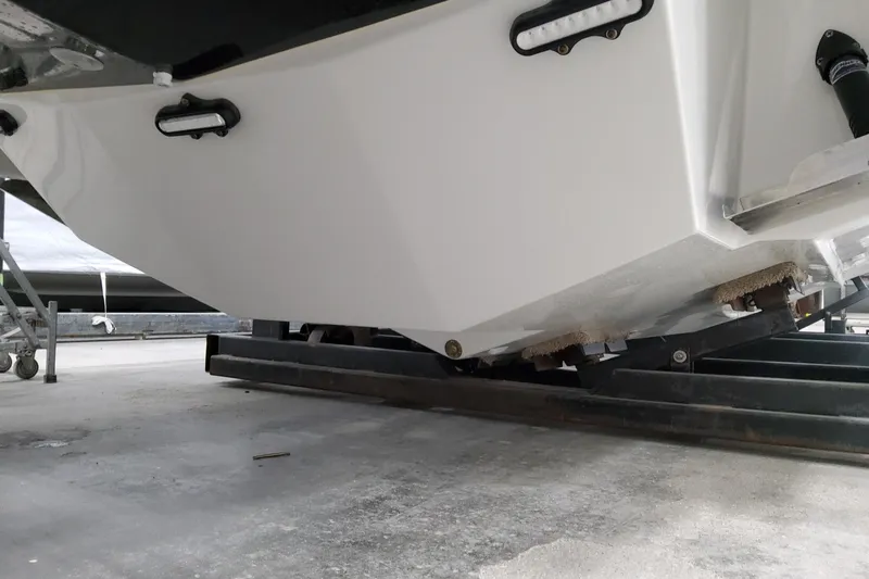 Slide: The Image of 2026 Formula 310 Bowrider OB boat hull on trailer, close-up view. - 17