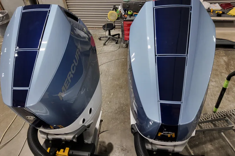 Slide: The Image of Twin Mercury outboard engines on a 2026 Formula 310 Bowrider OB in a workshop setting. - 18