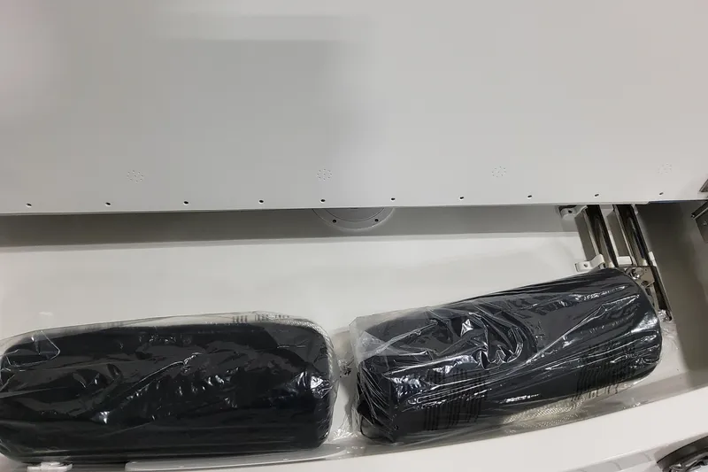 Slide: The Image of Storage compartment in 2026 Formula 310 Bowrider OB with packaged items inside. - 27