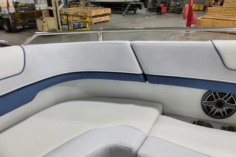 Slide: The Image of 2026 Formula 310 Bowrider OB interior with white and blue seating, speaker, and cup holders. - 34