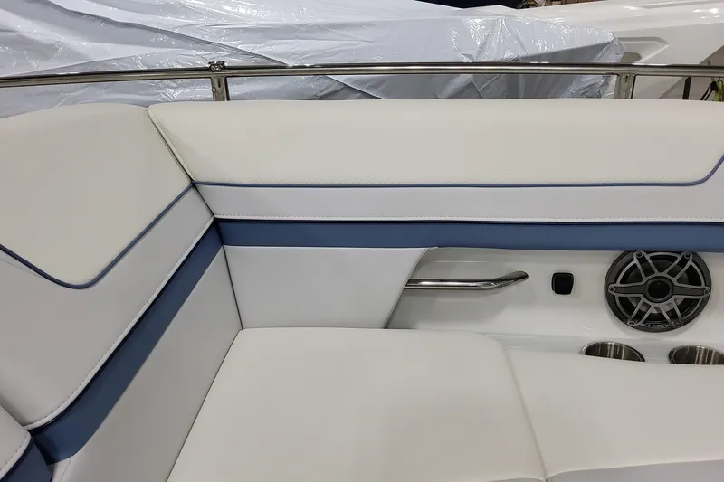 Slide: The Image of 2026 Formula 310 Bowrider OB interior with white and blue seating, speaker, and cup holders. - 38