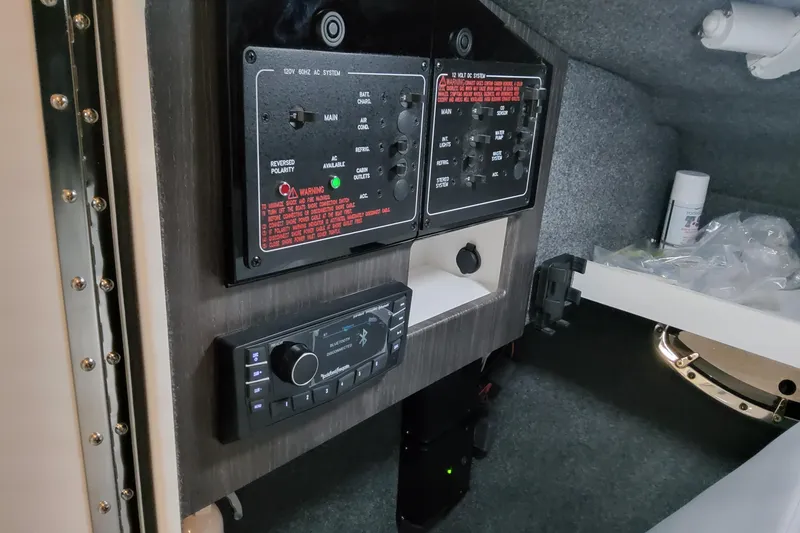 Slide: The Image of Control panel inside 2026 Formula 310 Bowrider OB boat, featuring electrical systems and stereo controls. - 42