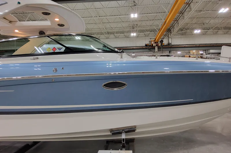 Slide: The Image of 2026 Formula 310 Bowrider OB in a showroom, showcasing sleek blue and white design. - 5