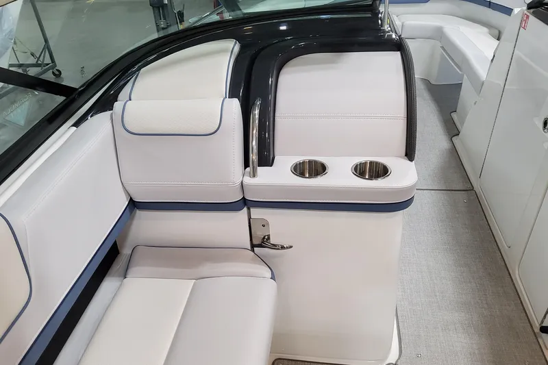 Slide: The Image of 2026 Formula 310 Bowrider OB interior with white seating and dual cup holders. - 54
