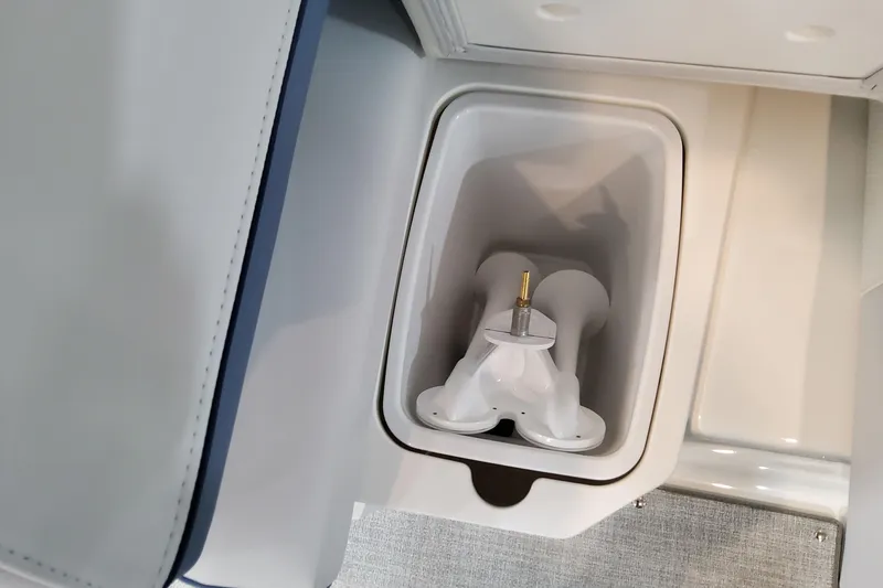 Slide: The Image of 2026 Formula 310 Bowrider OB boat storage compartment with integrated cup holder. - 65