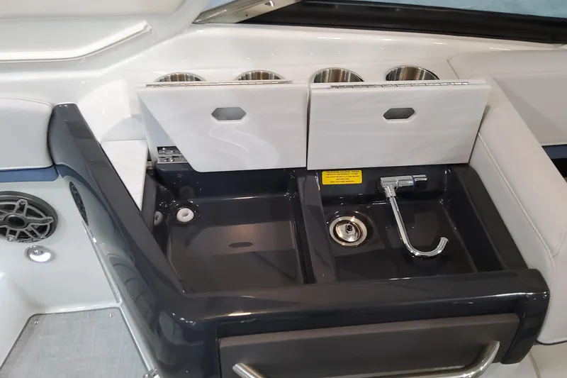 Slide: The Image of 2026 Formula 310 Bowrider OB boat interior with sink and storage compartments. - 68