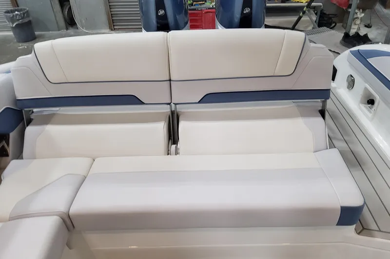 Slide: The Image of 2026 Formula 310 Bowrider OB boat interior seating with white and blue upholstery. - 76