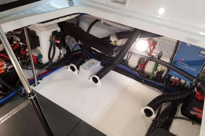 Slide: The Image of Engine compartment of 2026 Formula 310 Bowrider OB with wiring and battery charger. - 84