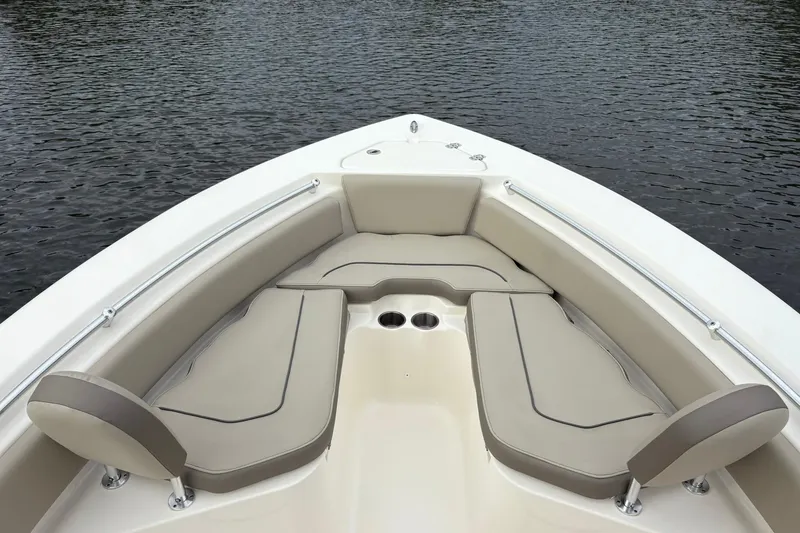 Slide: The Image of 2023 Key West 219 FS boat interior with cushioned seating and cup holders. - 10