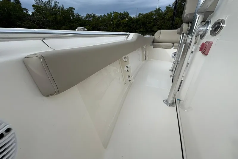 Slide: The Image of 2023 Key West 219 FS boat interior with cushioned seating and stainless steel railings. - 15