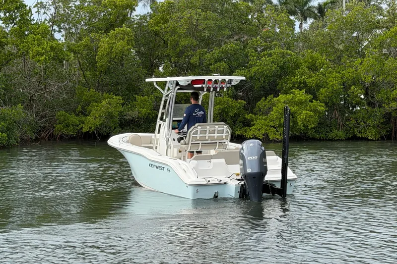 Slide: The Image of 2023 Key West 219 FS boat navigating through lush mangroves. - 3