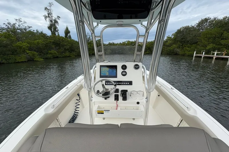 Slide: The Image of 2023 Key West 219 FS boat dashboard with steering wheel and navigation screen. - 6