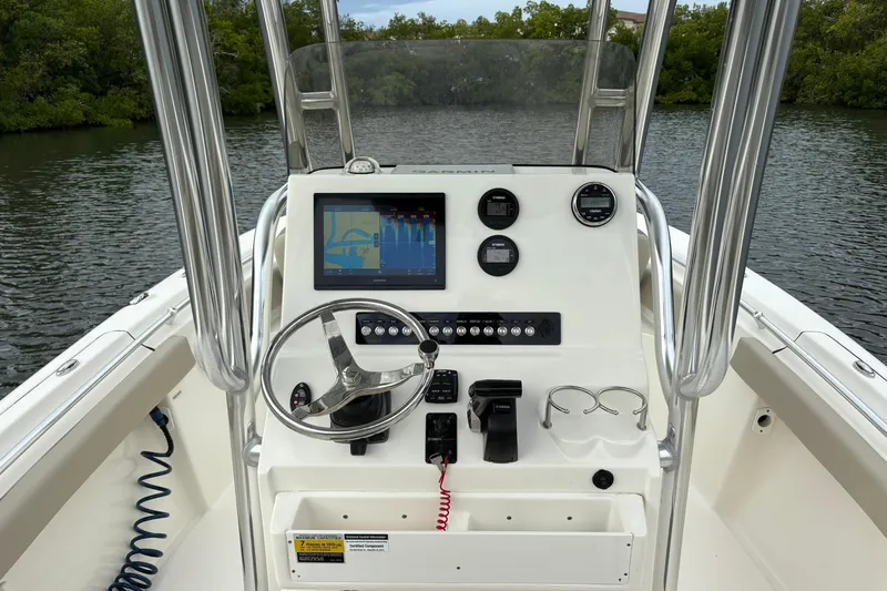 Slide: The Image of 2023 Key West 219 FS boat dashboard with steering wheel and navigation display. - 7