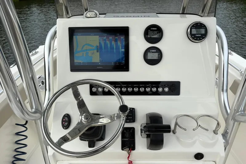 Slide: The Image of 2023 Key West 219 FS boat dashboard with Garmin display and controls. - 8