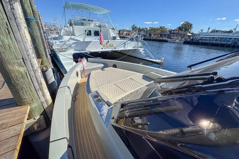 Slide: The Image of 2026 De Antonio Yachts D32 docked, showcasing sleek design and luxurious deck features. - 34