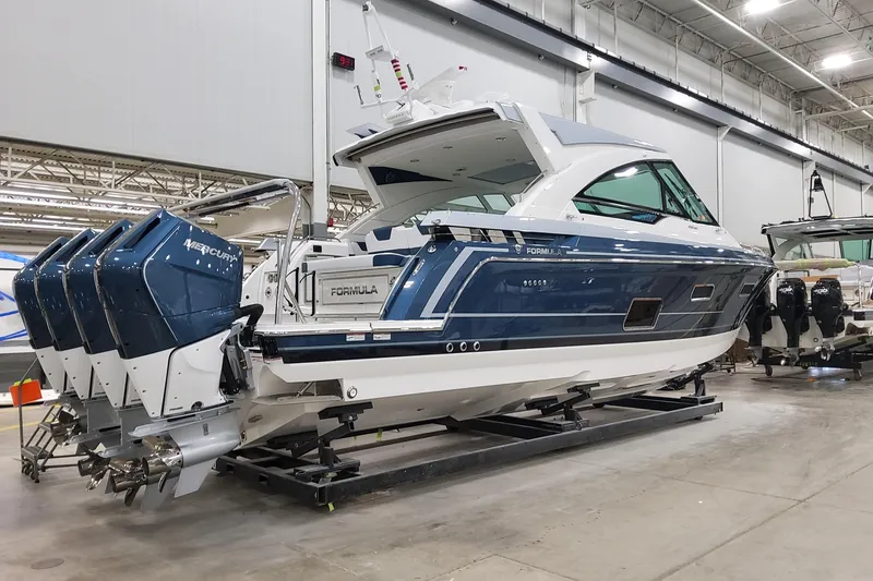 The Image of 2026 Formula 400 Super Sport Crossover boat with Mercury engines in a showroom. - 1