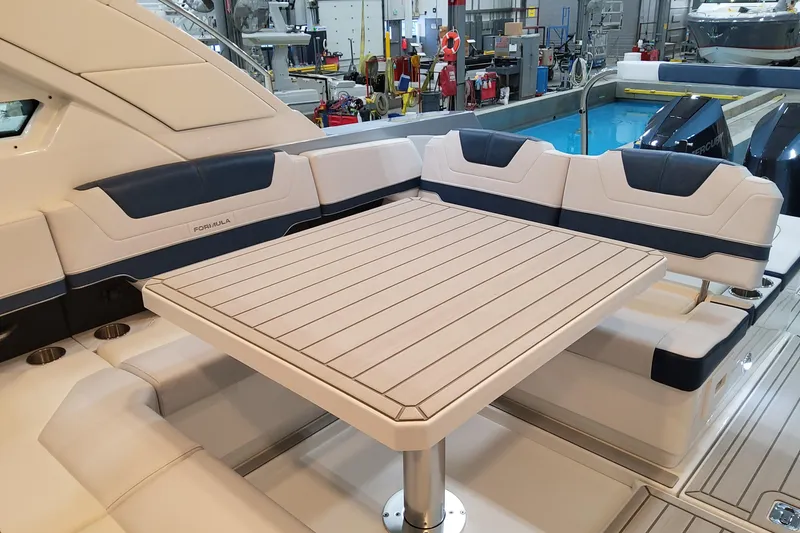 Slide: The Image of Luxury seating area on 2026 Formula 400 Super Sport Crossover yacht with elegant table design. - 12