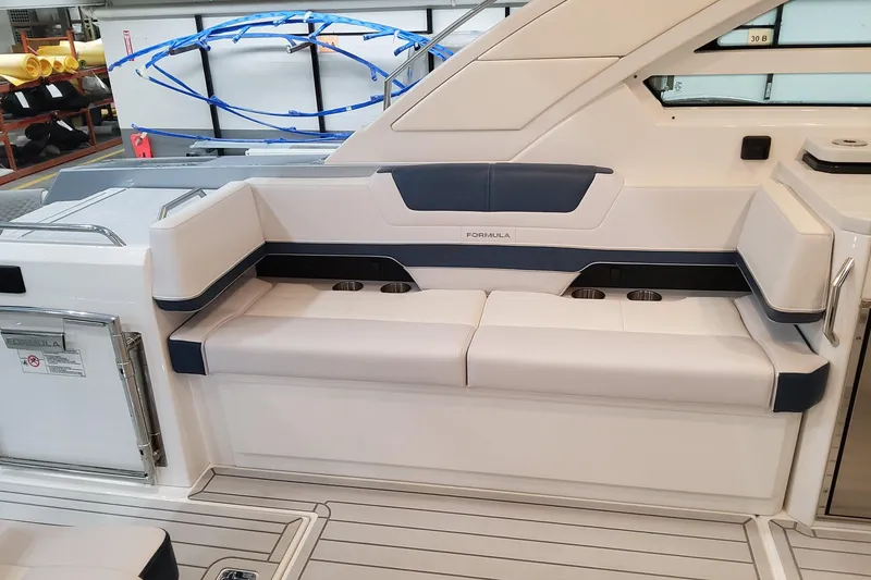 Slide: The Image of 2026 Formula 400 Super Sport Crossover boat interior with sleek seating and cup holders. - 14