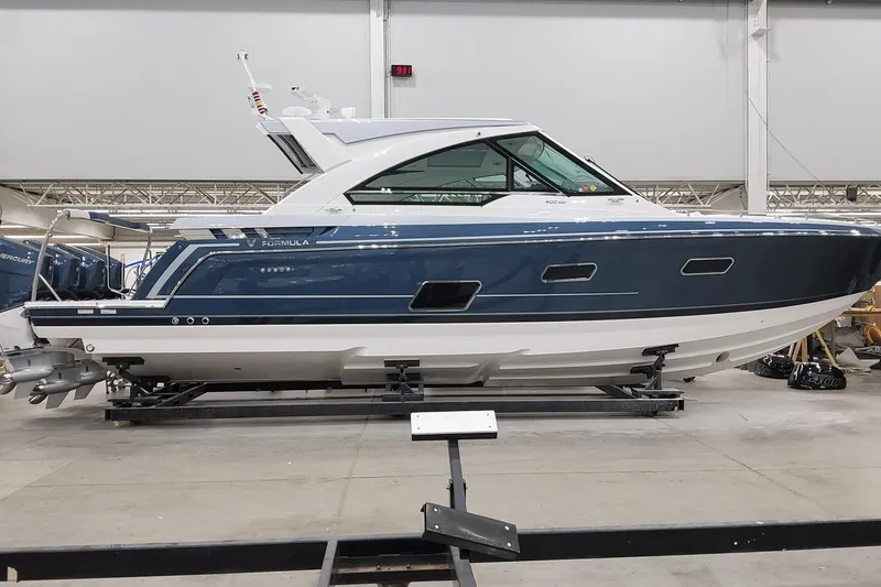 Slide: The Image of 2026 Formula 400 Super Sport Crossover boat in a showroom, side view. - 2