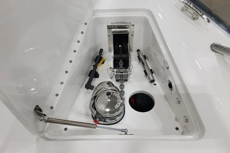 Slide: The Image of Anchor compartment of 2026 Formula 400 Super Sport Crossover boat, featuring winch and chain. - 37