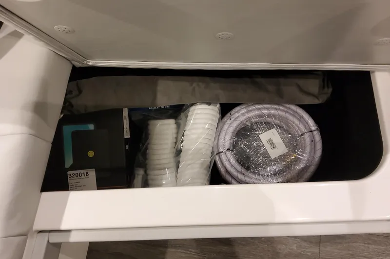 Slide: The Image of Storage compartment in 2026 Formula 400 Super Sport Crossover with coiled rope and accessories. - 41