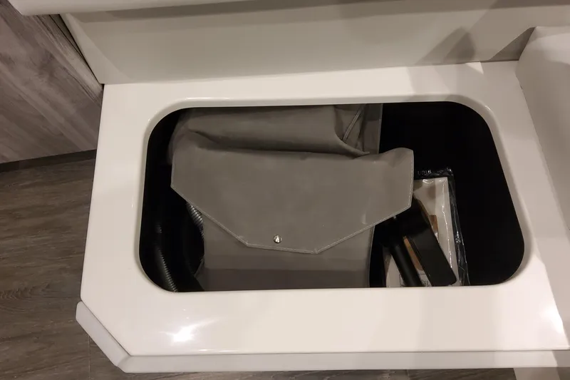Slide: The Image of Storage compartment in 2026 Formula 400 Super Sport Crossover, featuring a gray bag and accessories. - 42