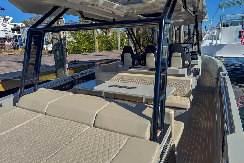 Slide: The Image of 2026 De Antonio Yachts D32 with luxurious seating and modern design at a marina. - 11