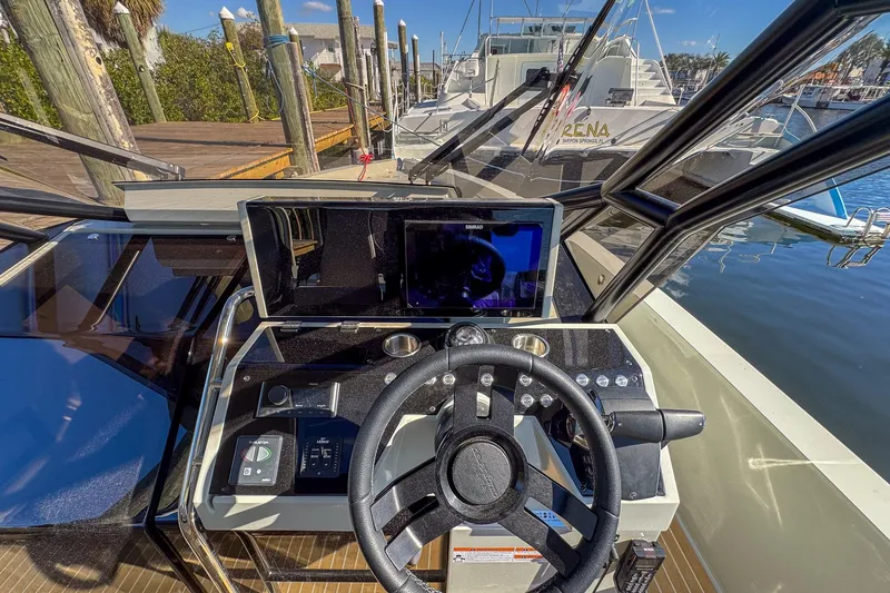 Slide: The Image of Helm of 2026 De Antonio Yachts D32, featuring modern navigation controls and steering wheel. - 22