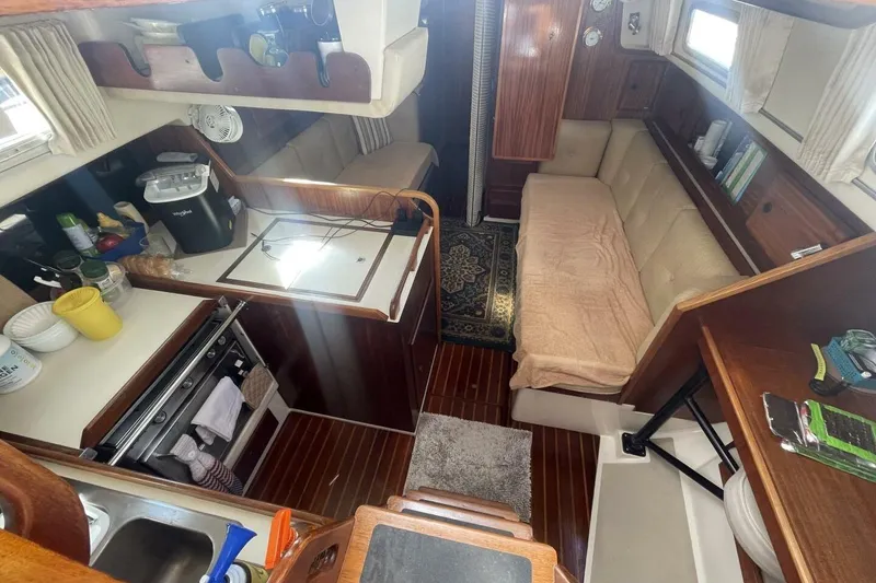 Slide: The Image of Interior of 1981 Pearson 36 sailboat with cozy seating and compact kitchen area. - 13