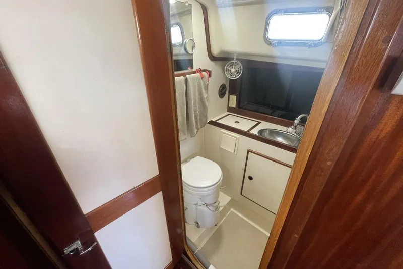 Slide: The Image of 1981 Pearson 36 yacht bathroom with sink, toilet, and wooden accents. - 17