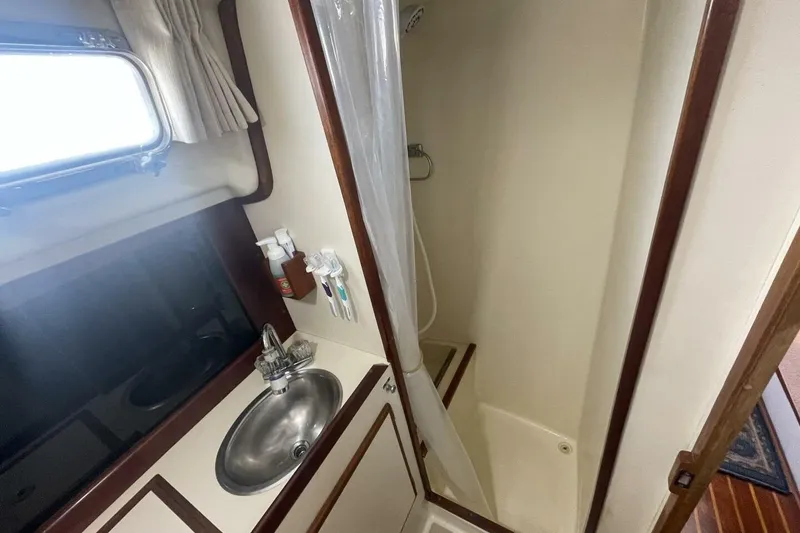 Slide: The Image of 1981 Pearson 36 yacht bathroom with sink, shower, and window. - 19