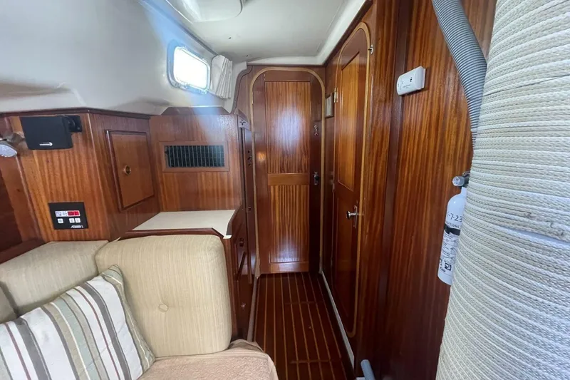 Slide: The Image of Interior of 1981 Pearson 36 sailboat with wood paneling and cozy seating area. - 20